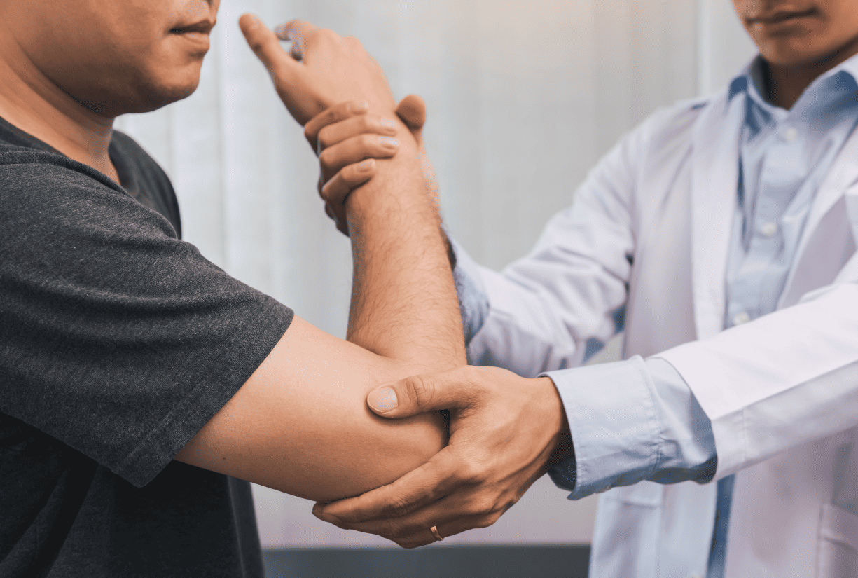 medical professional examining patient arm and elbow