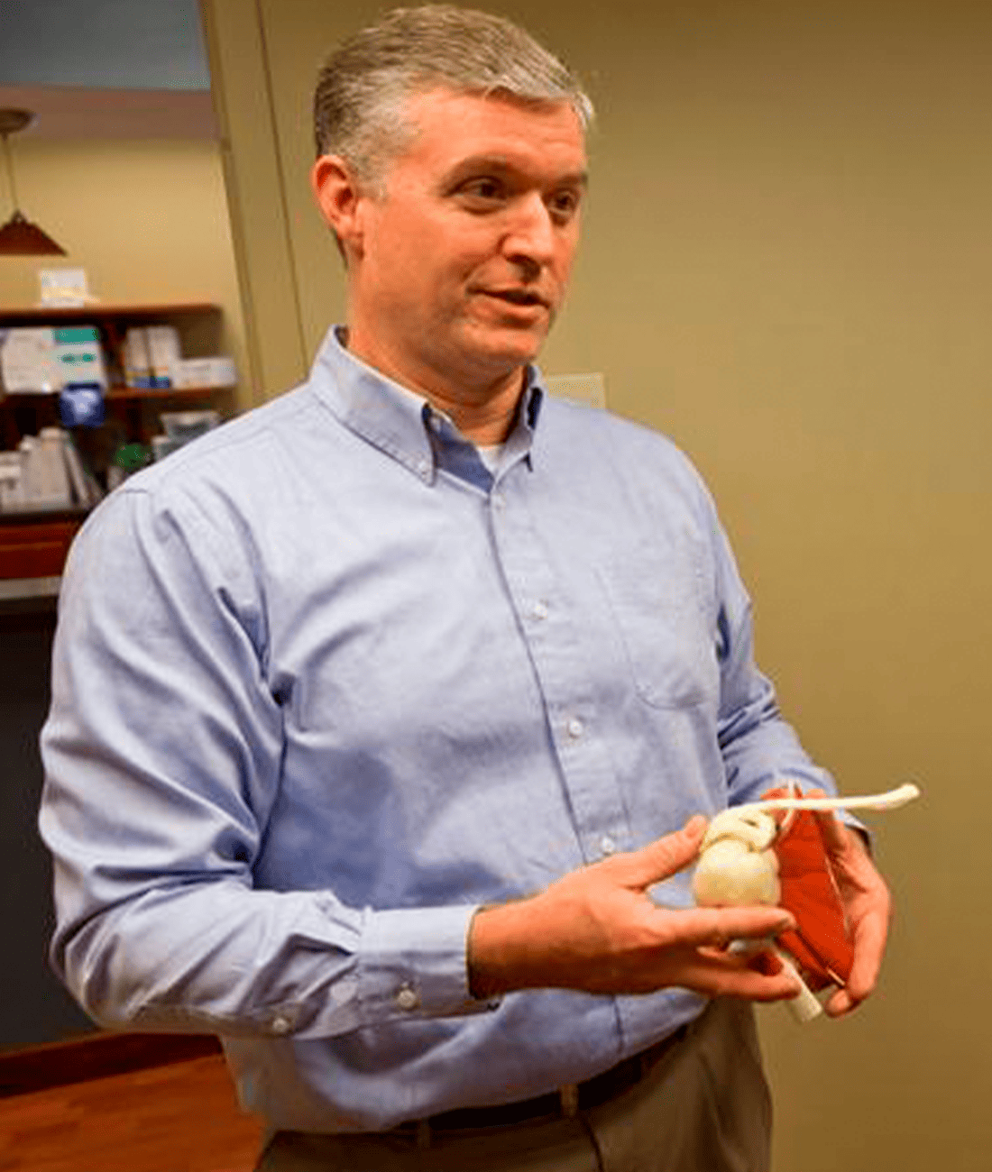 Matthew Davis, M.D. holding anatomical model
