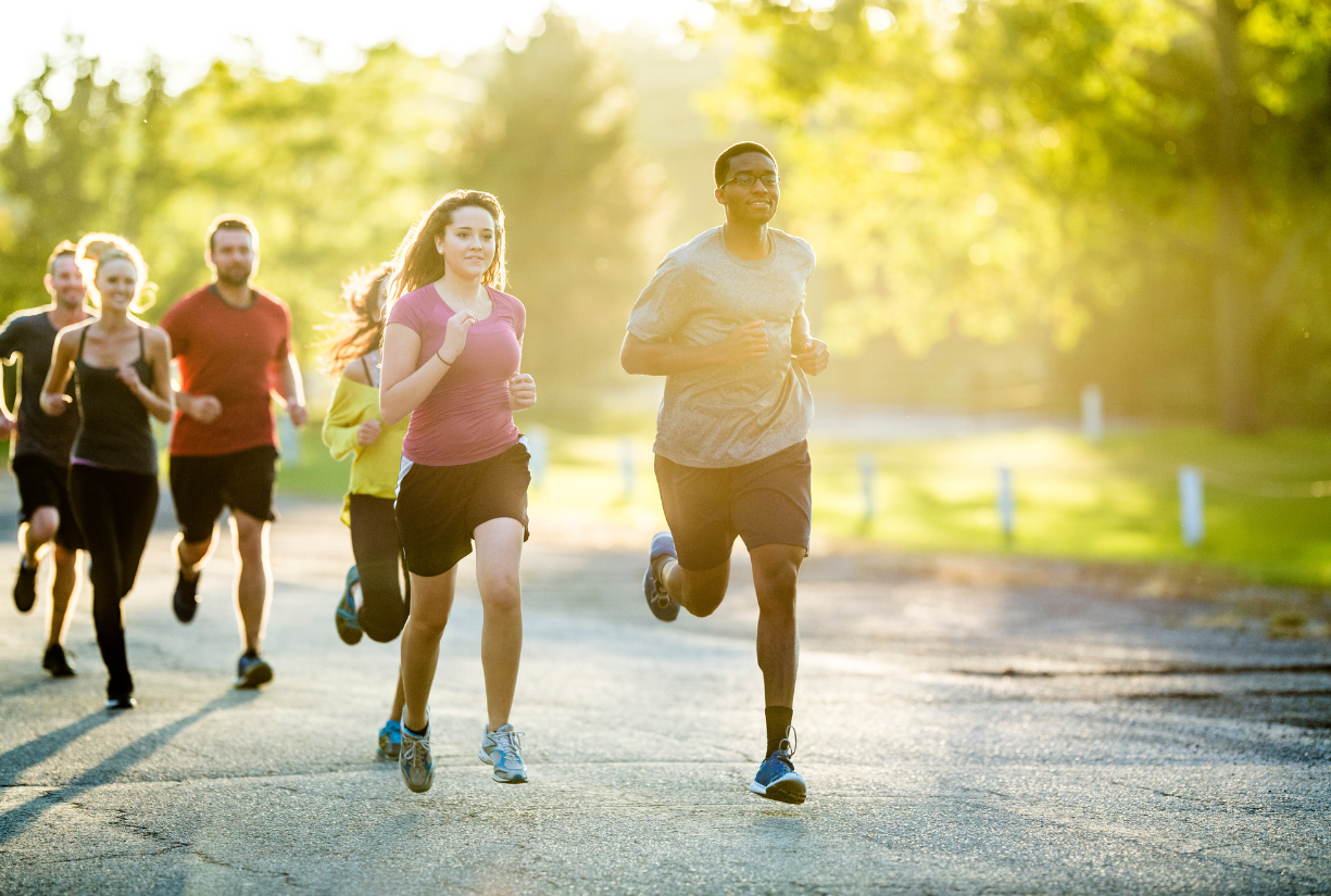 group of young adults jogging outside