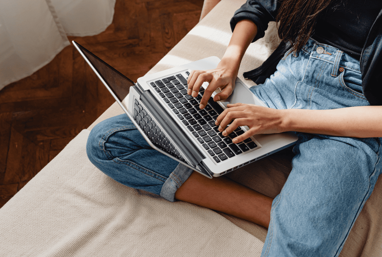 woman at home typing on laptop