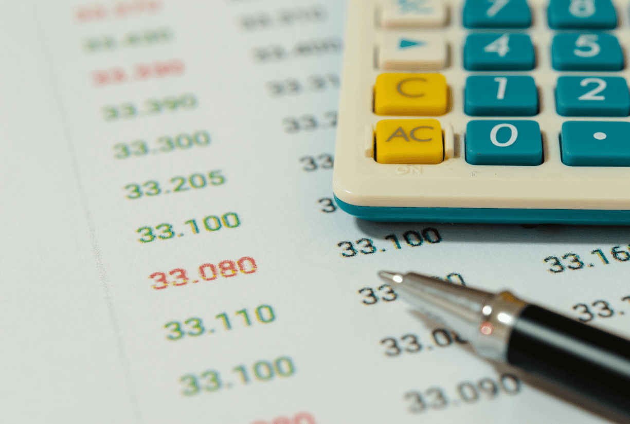 calculator, pen, and financial spreadsheet