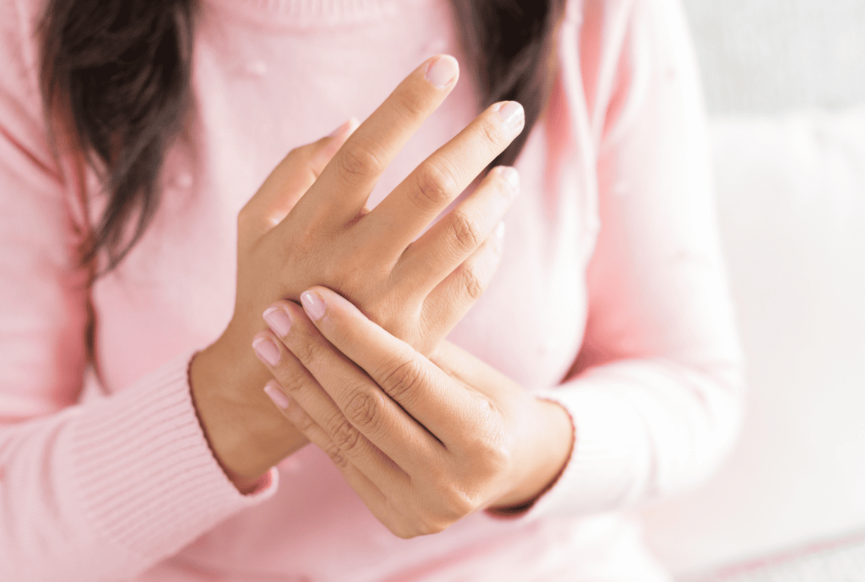 woman holding and examining back of her own hand