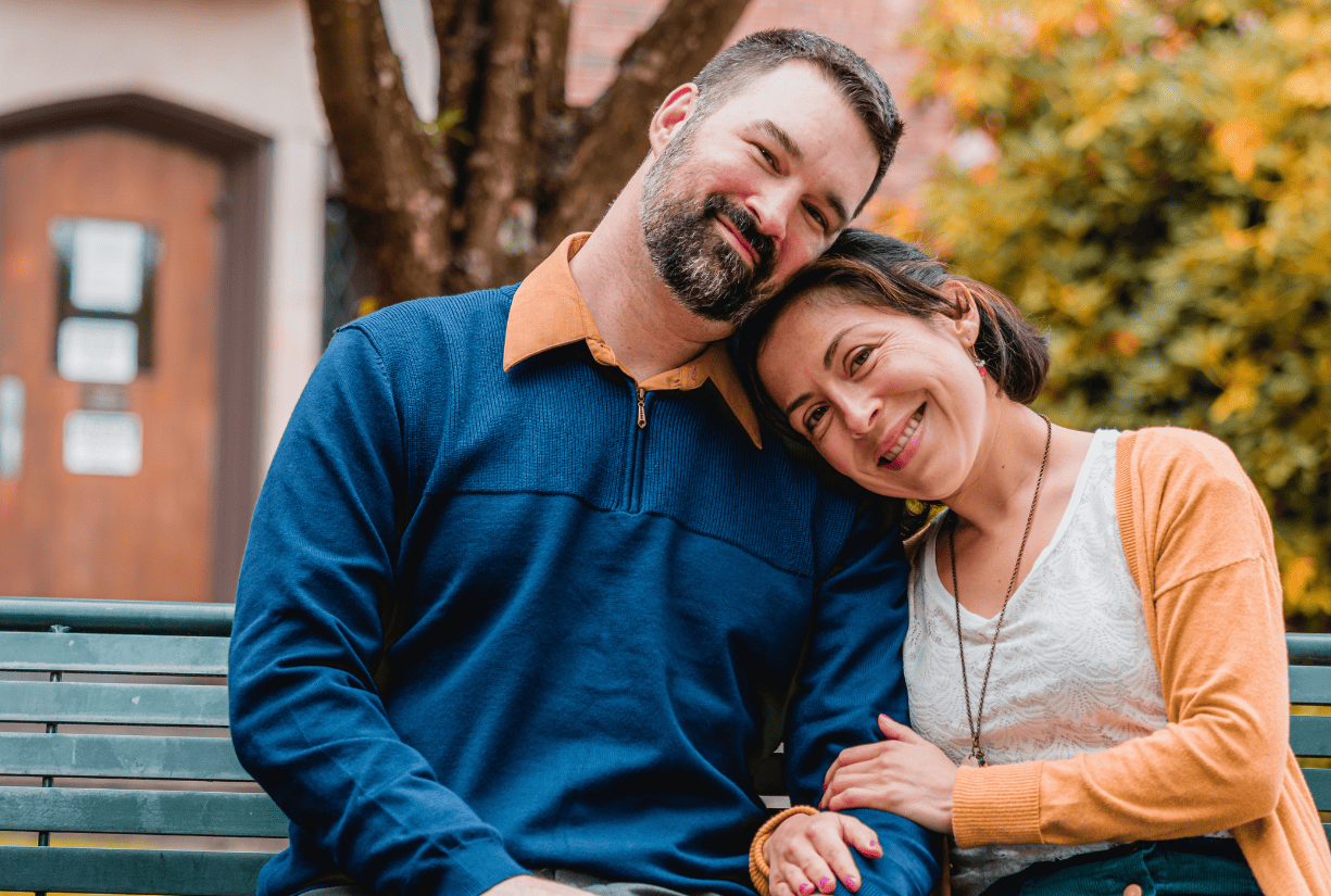 middle aged couple sitting on bench