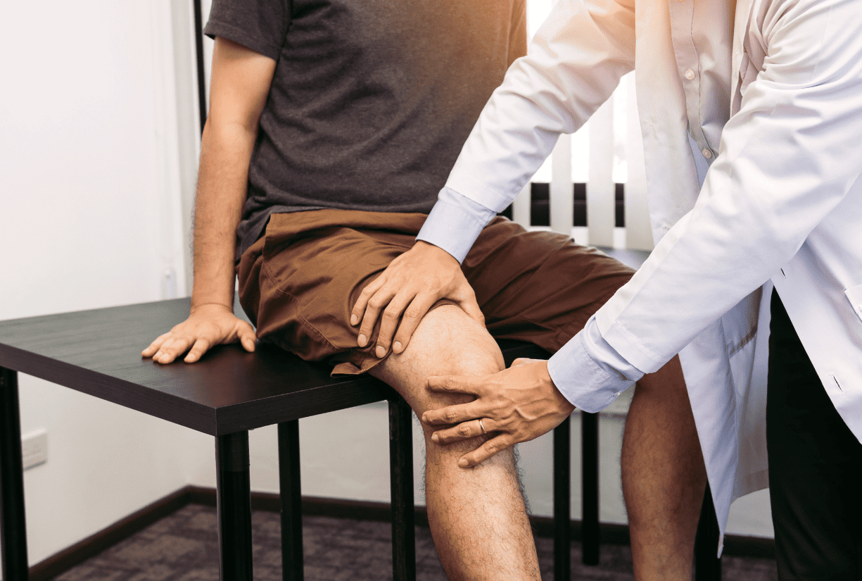 medical professional examining patient knee