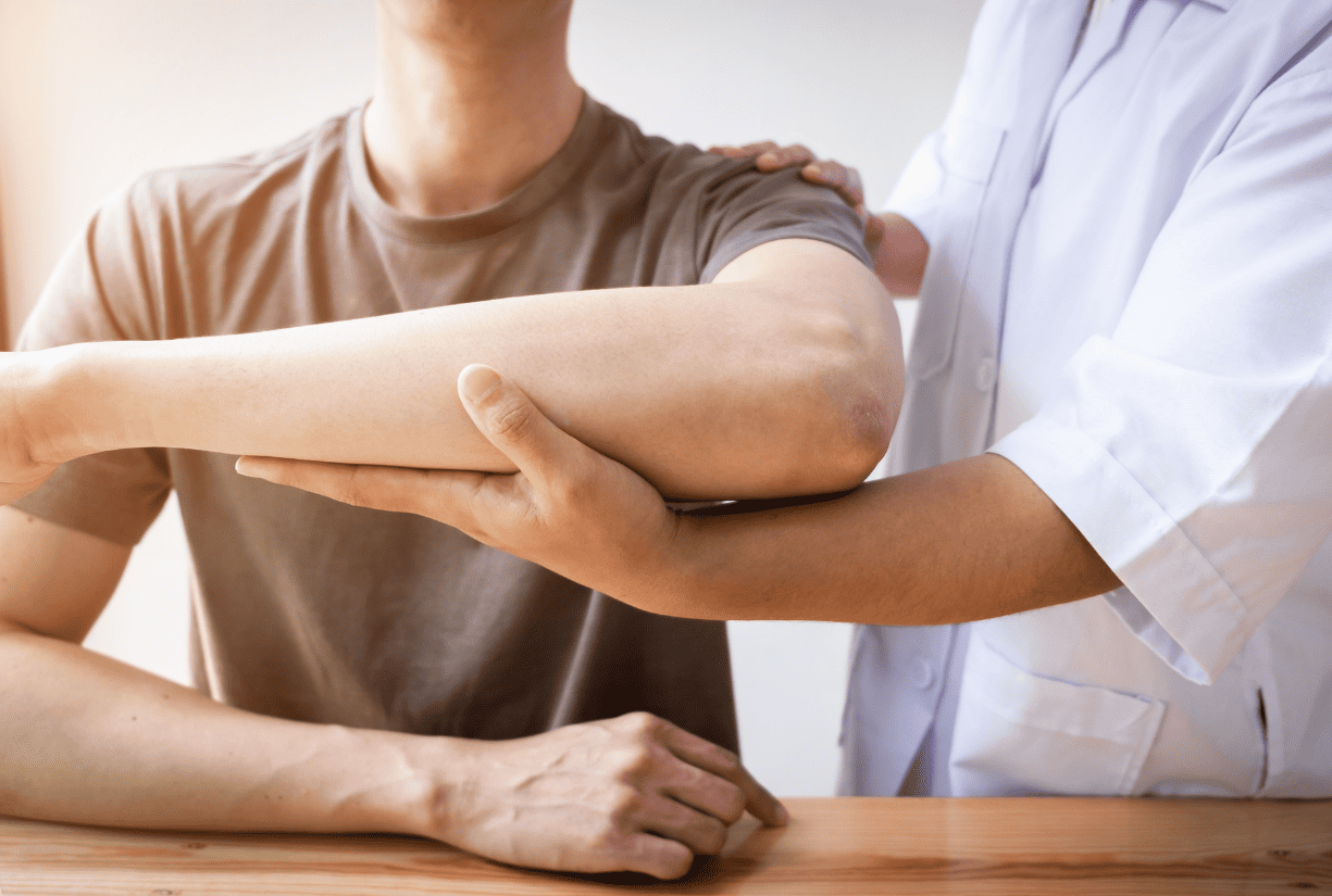 medical professional inspecting patient arm and shoulder
