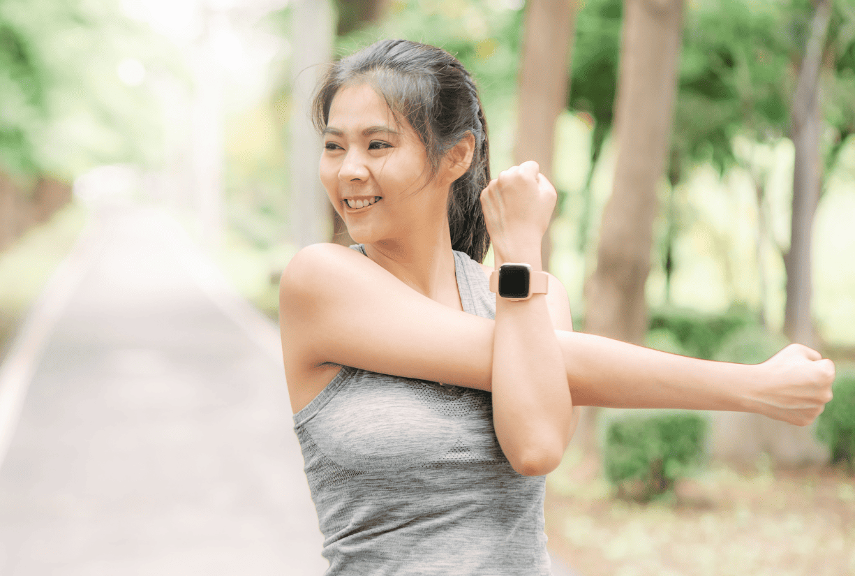 woman stretching arms outside