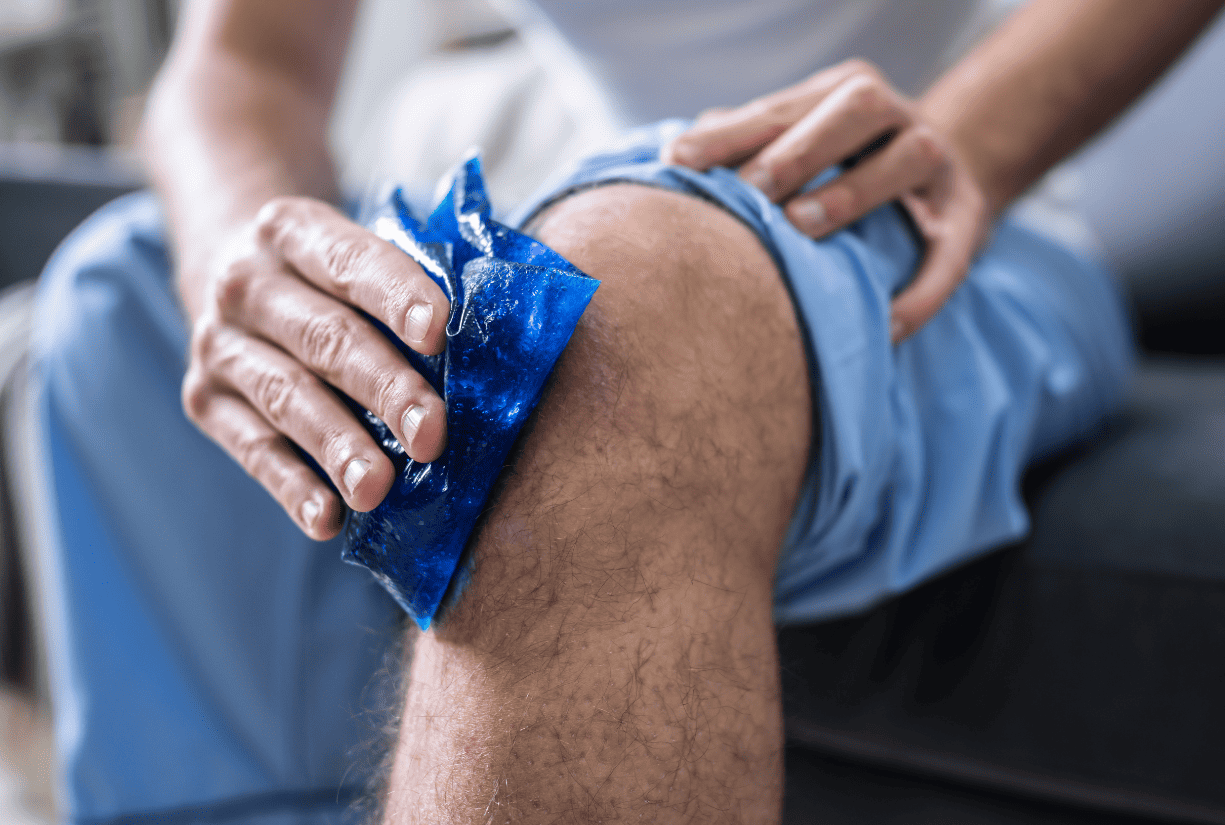 man holding ice pack on knee