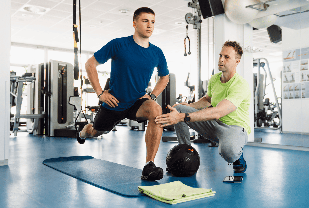 Personal physical trainer assisting patient