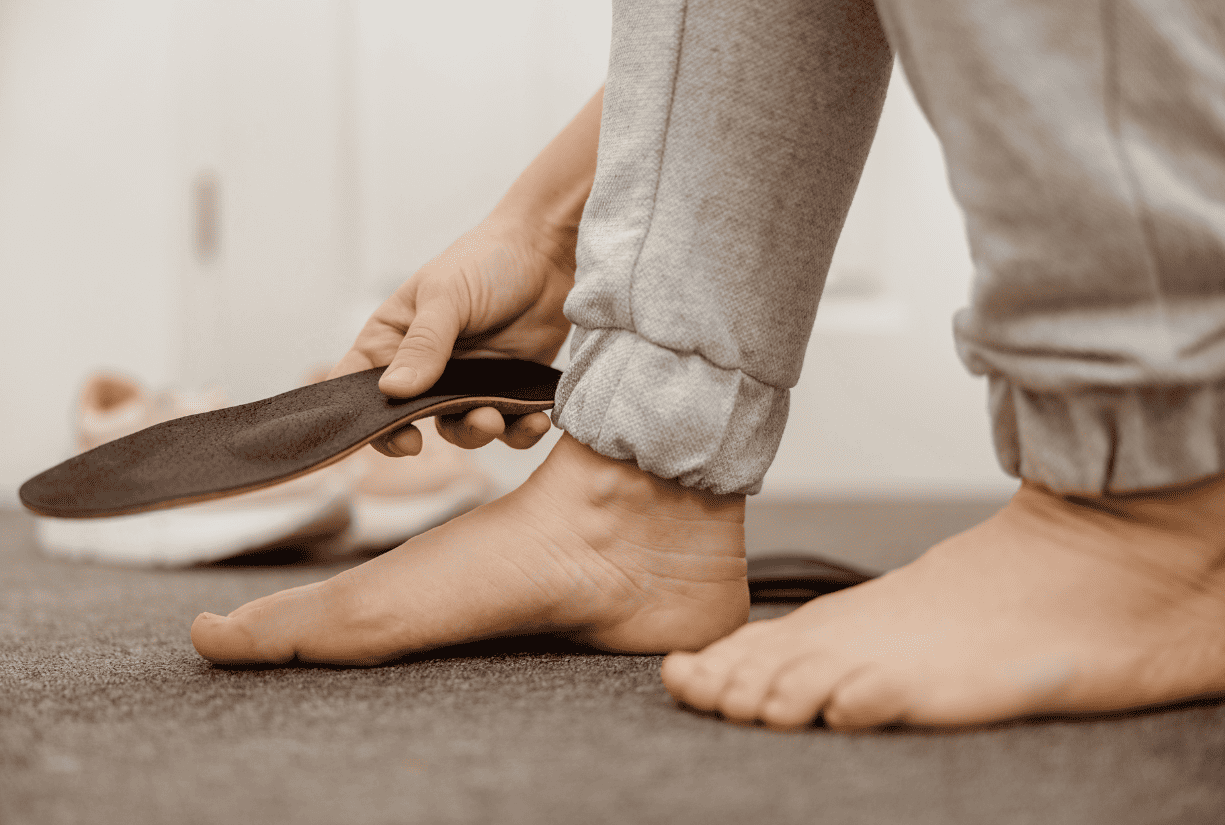 person holding shoe insoles