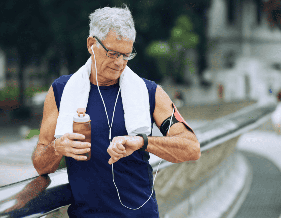 Senior man checking time while exercising